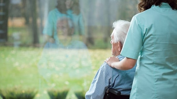 man-in-wheelchair-staring-out-of-care-home-window.jpg