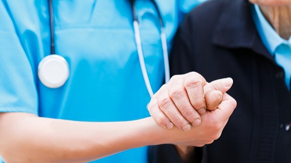 medical-person-in-scrubs-holding-elderly-persons-hand.jpg.jpg