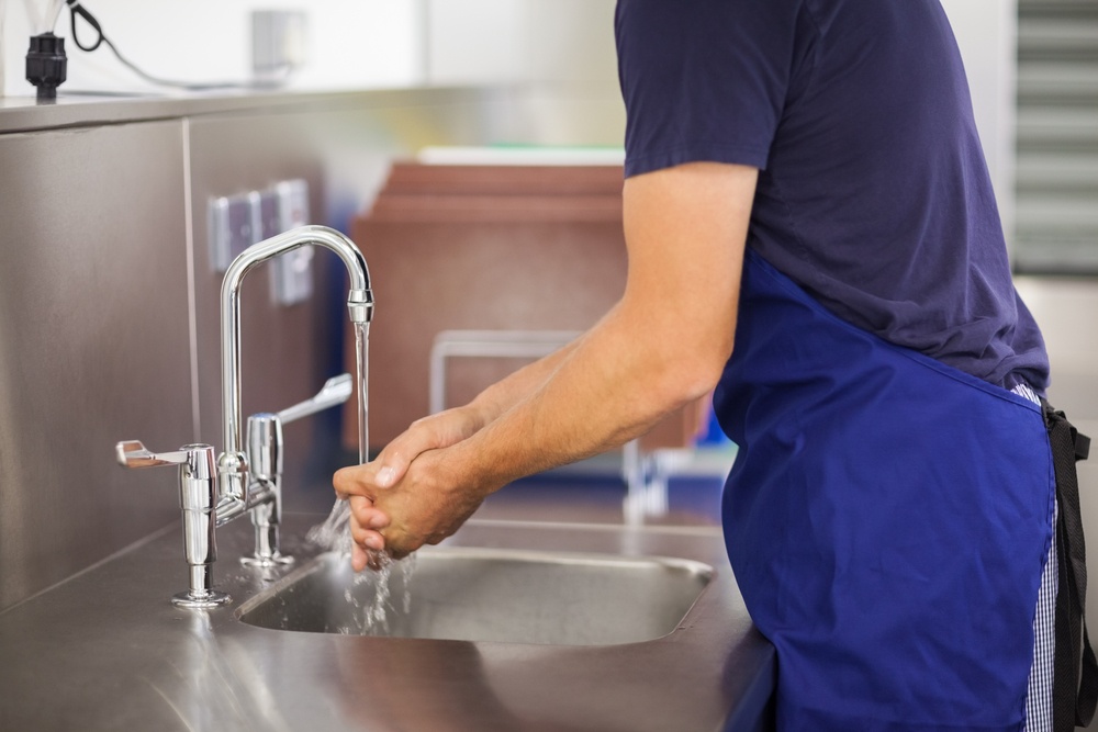 Kitchen porter washing his hands in professional kitchen-1.jpeg